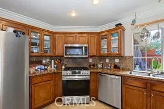a kitchen with stainless steel appliances a stove sink and microwave