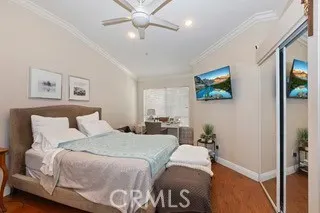 a bedroom with a large bed and a chandelier