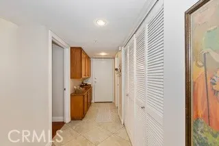 a view of a hallway with a cabinet and a bathroom