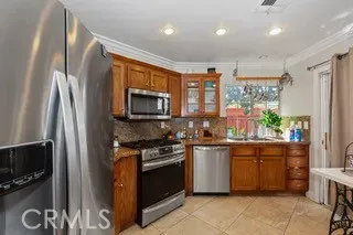 a kitchen with stainless steel appliances granite countertop a stove a sink and a refrigerator
