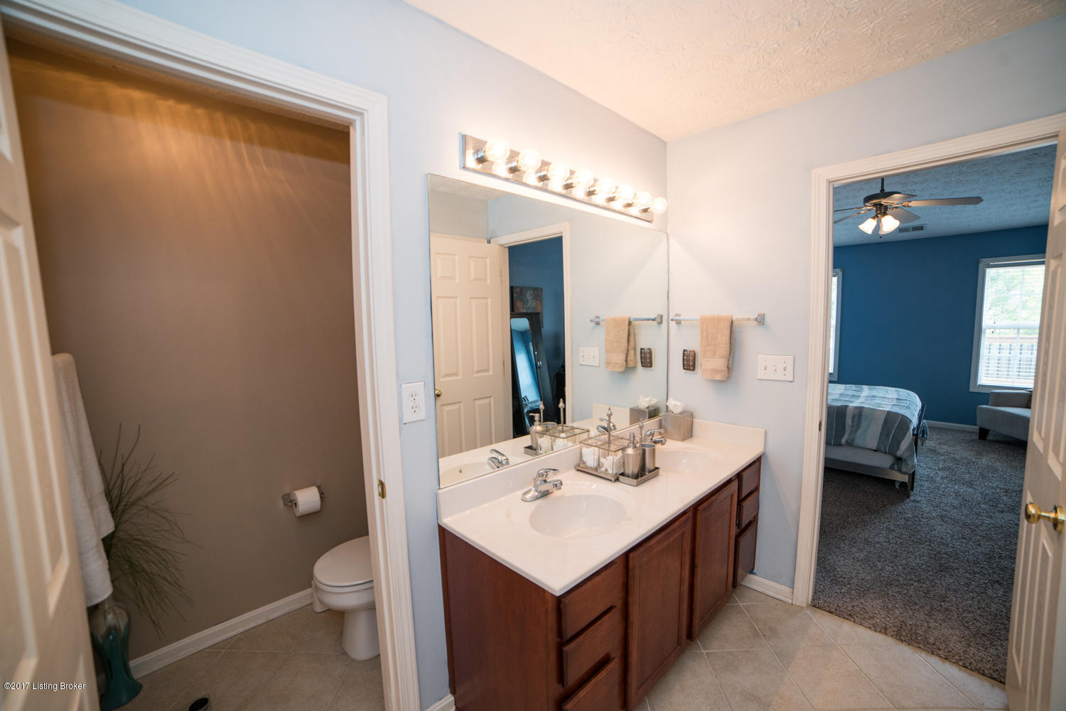 17520 Curry Branch Road Louisville, KY 40245 - Photo 22 of 45 The double vanity is detailed with wood cabinetry and accented with coordinating vanity mirror and light fixture