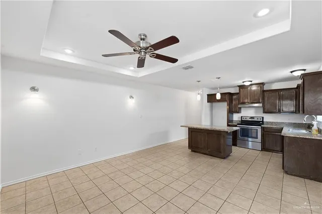 a view of a kitchen with a sink and a refrigerator