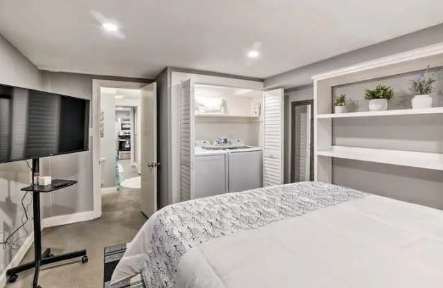 a bedroom with a bed and a flat screen tv