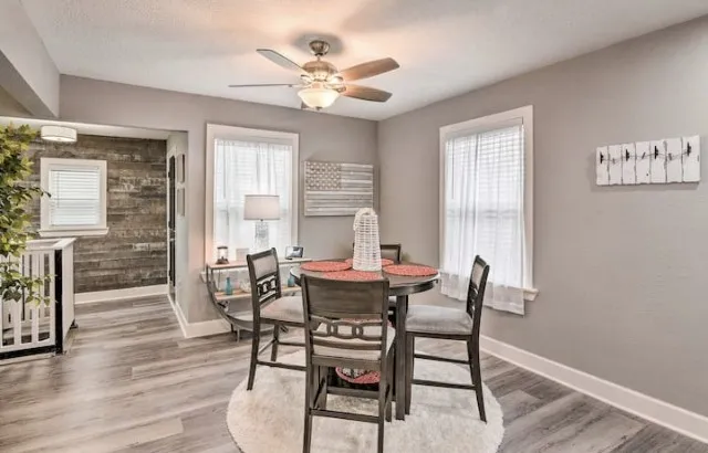 a dining room with furniture a chandelier and wooden floor