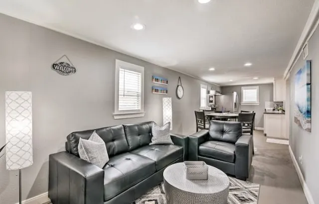 a living room with furniture and a wooden floor