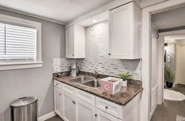 a kitchen with stainless steel appliances granite countertop a sink stove and cabinets