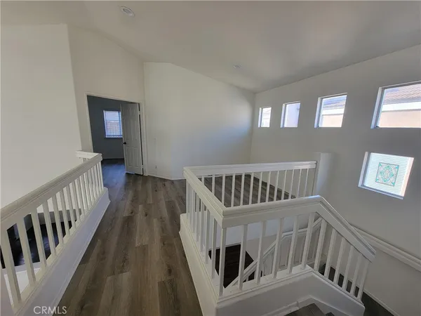a view of staircase with railing and a window