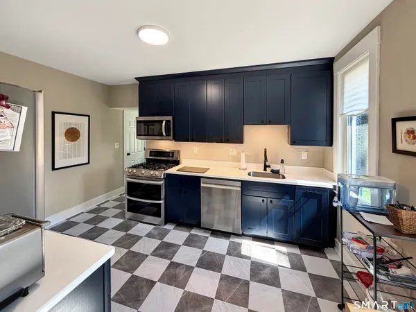 a kitchen with a sink and a stove top oven