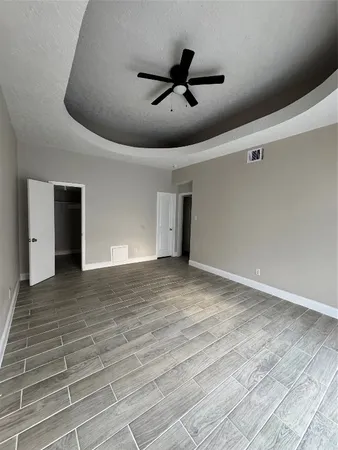 a view of a livingroom with a ceiling fan and wooden floor