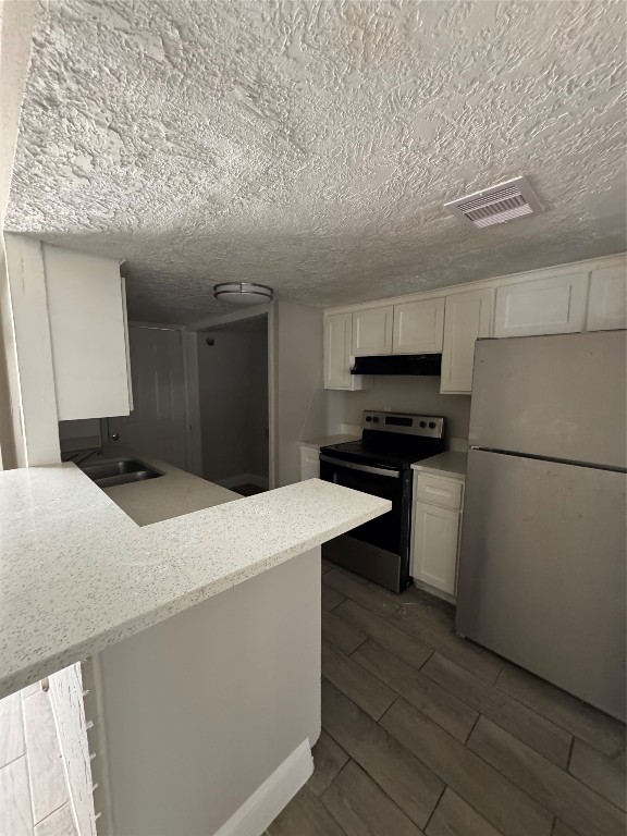 8100 Leonora Street, Unit K3 Houston, TX 77061 - Photo 4 of 15 a kitchen with stainless steel appliances kitchen island granite countertop a refrigerator a stove and a sink