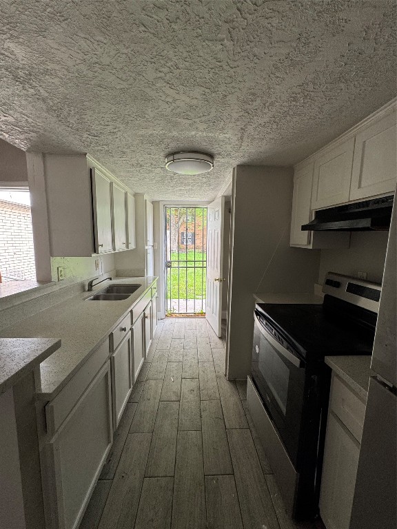 8100 Leonora Street, Unit K3 Houston, TX 77061 - Photo 5 of 15 a kitchen with granite countertop a stove sink and cabinets