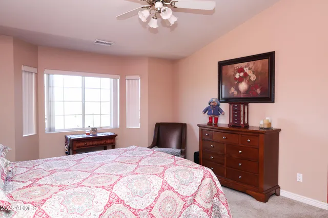 a bedroom with a bed and a dresser