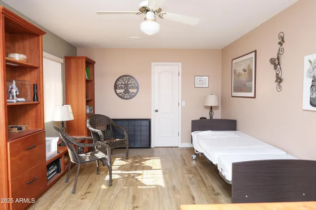 a spacious bedroom with a bed and a chandelier