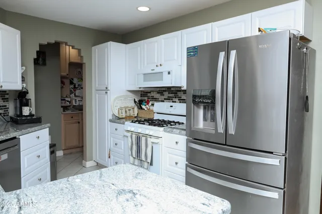 a kitchen with stainless steel appliances a refrigerator stove and sink