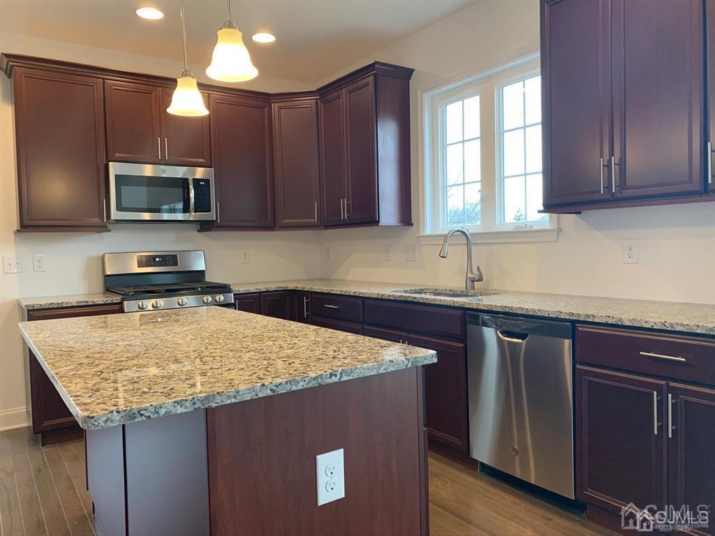 21 May Road East Brunswick, NJ 08816 - Photo 7 of 18 a kitchen with kitchen island granite countertop a sink window and refrigerator