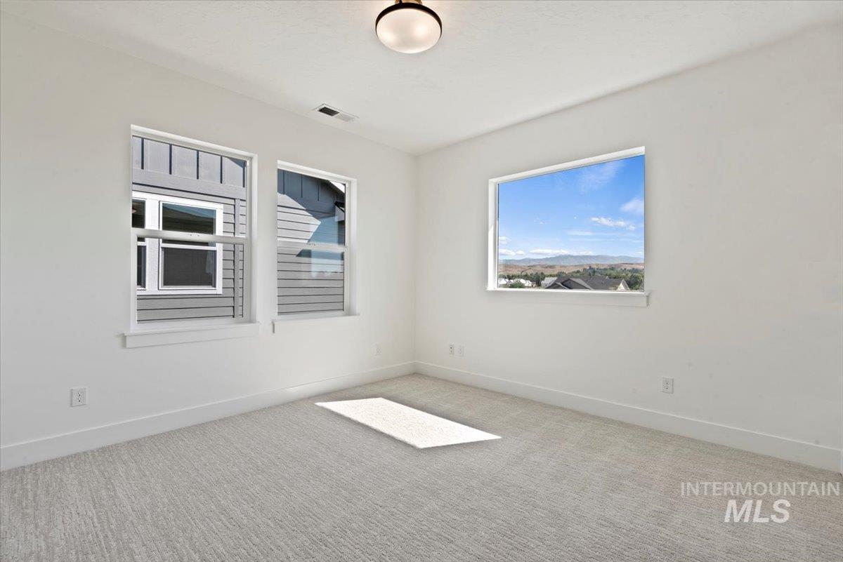 677 North Morning Glory Way Eagle, ID 83616 - Photo 15 of 29 Carpeted empty room featuring baseboards