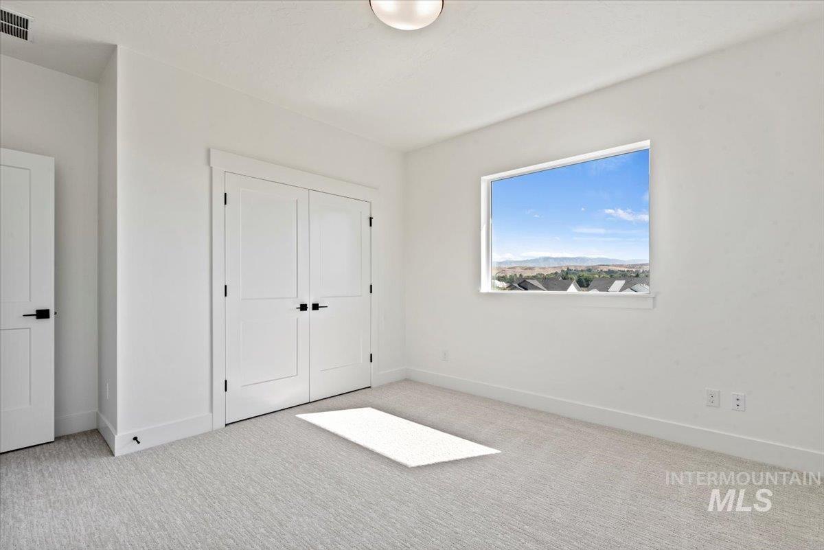 677 North Morning Glory Way Eagle, ID 83616 - Photo 16 of 29 Unfurnished bedroom with carpet flooring and a closet