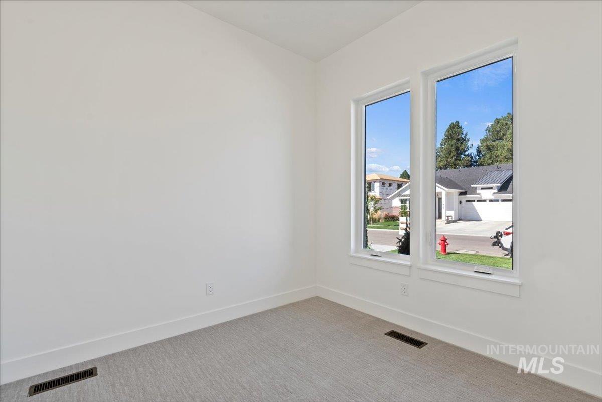 677 North Morning Glory Way Eagle, ID 83616 - Photo 17 of 29 Unfurnished room with baseboards and carpet flooring