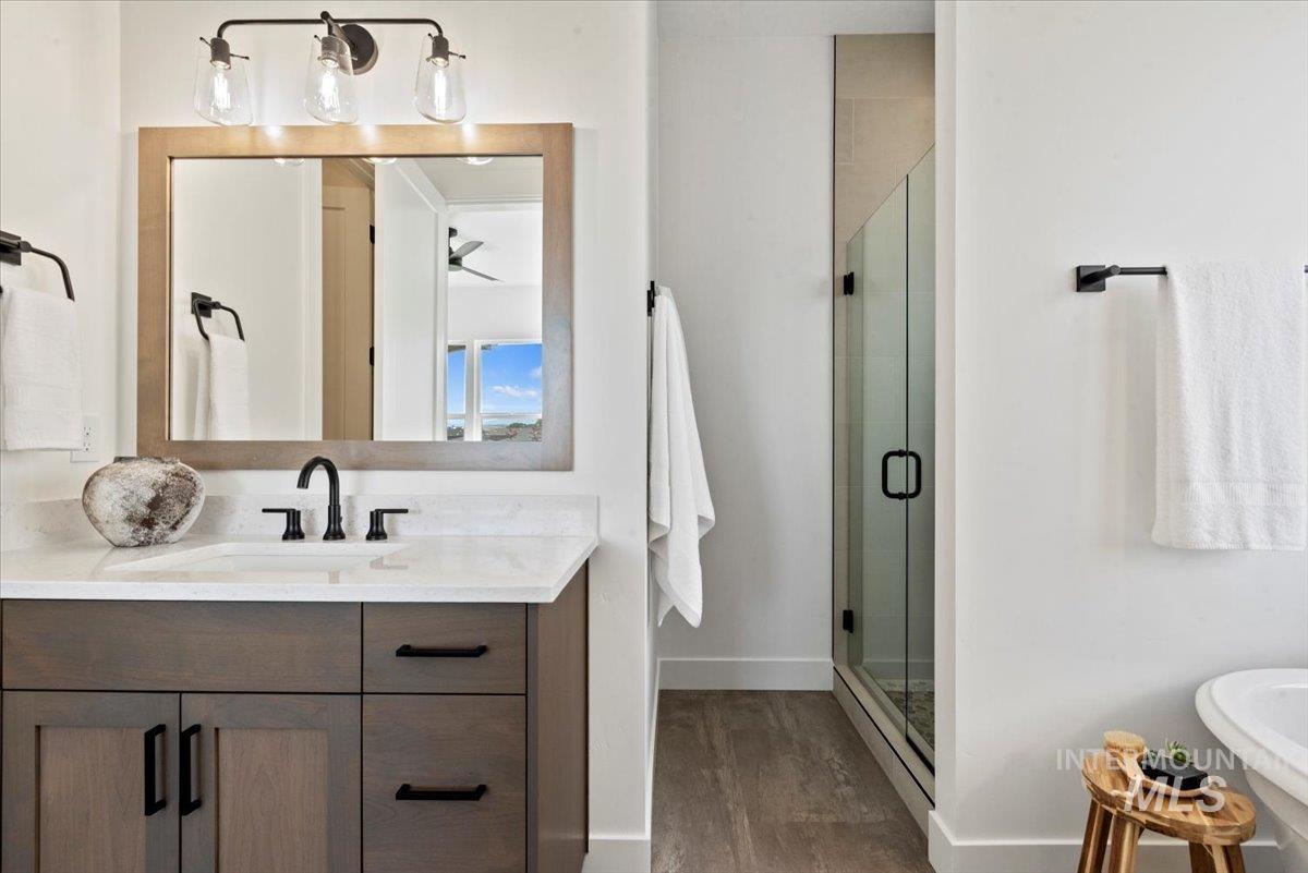677 North Morning Glory Way Eagle, ID 83616 - Photo 20 of 29 Full bathroom with a shower stall, vanity, a freestanding bath, and dark wood-style floors