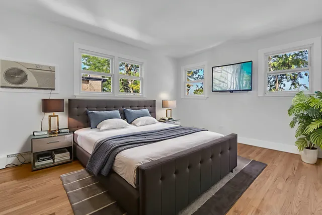 a bedroom with a bed and a window