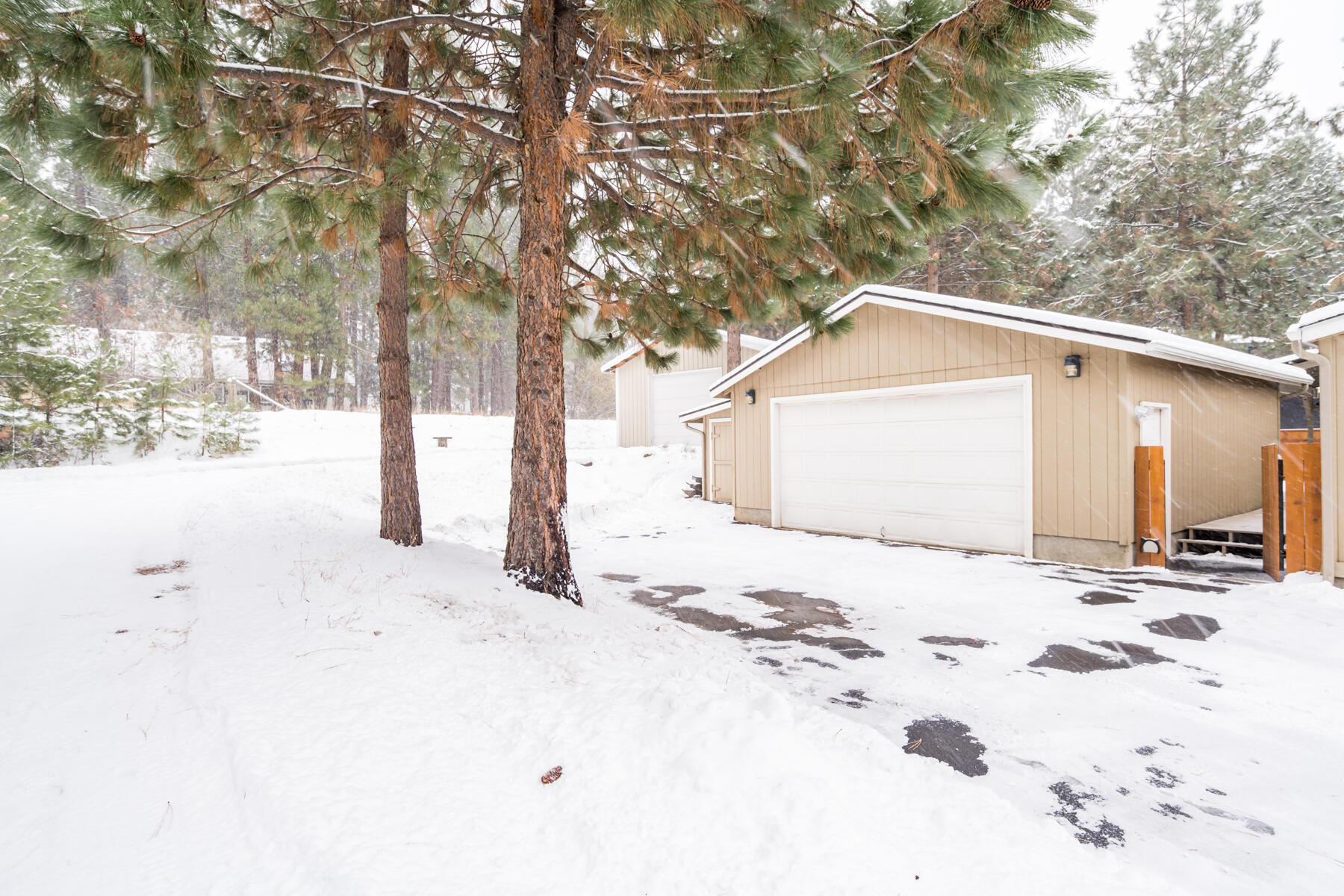 19271 Indian Summer Road Bend, OR 97702 - Photo 6 of 48 a front view of a house with a yard covered in snow