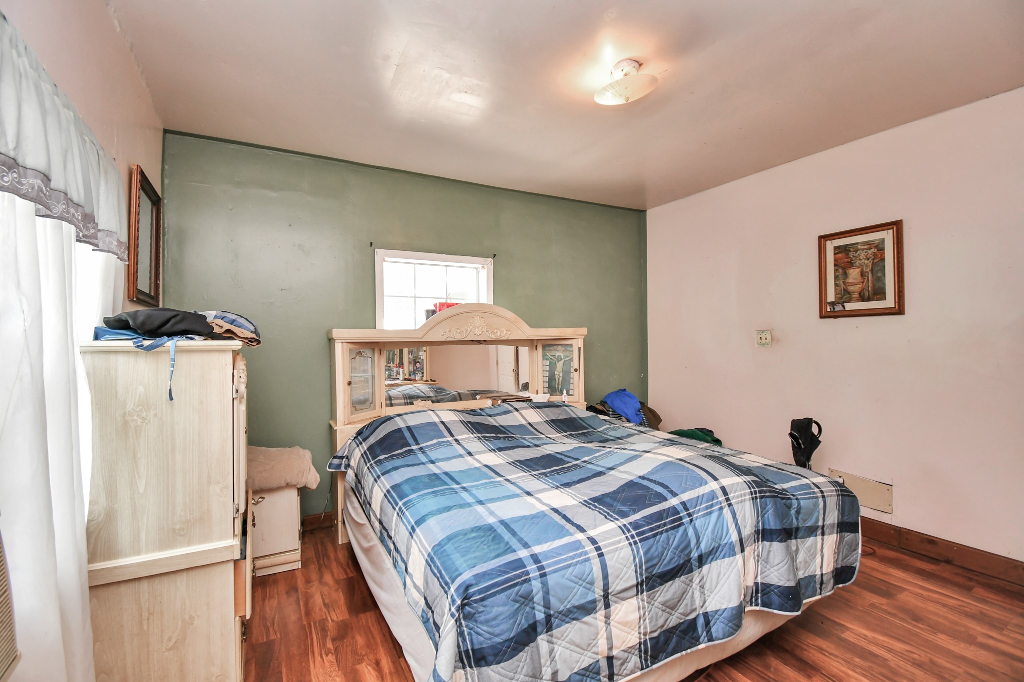 7908 John Street Houston, TX 77012 - Photo 18 of 30 a bedroom with a bed and a refrigerator
