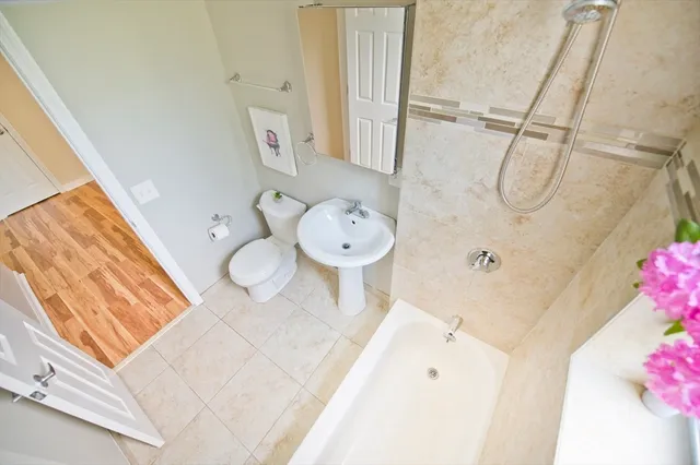 a bathroom with a sink mirror and toilet