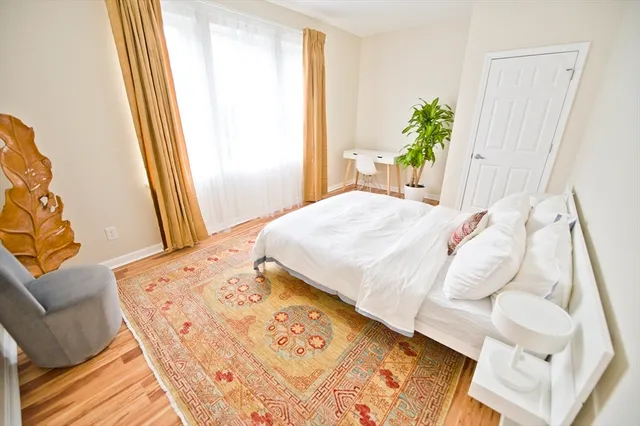 a bed sitting in a bedroom next to a window
