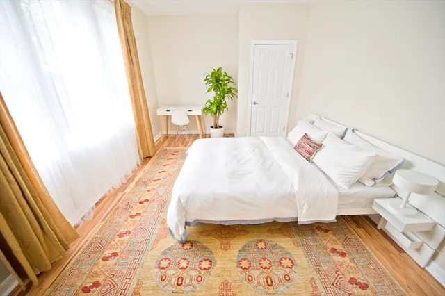 a bedroom with a bed and a window