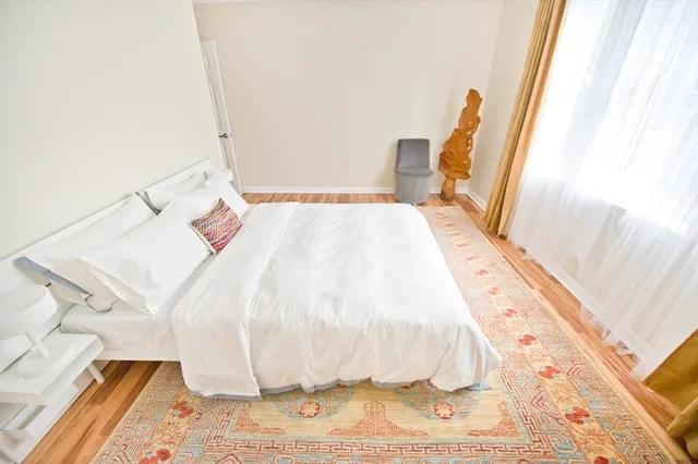a bed sitting in a bedroom next to a window