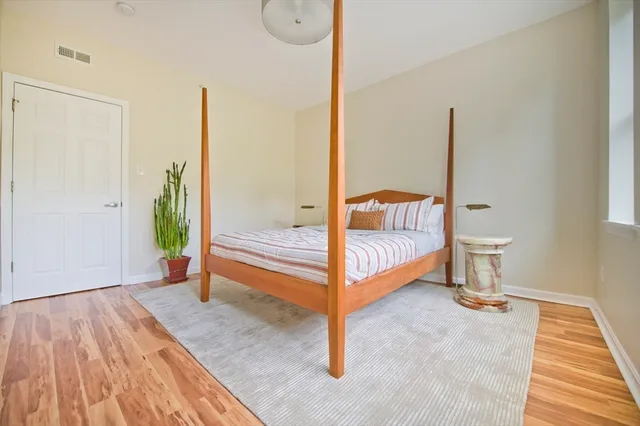 a spacious bedroom with a bed and a table