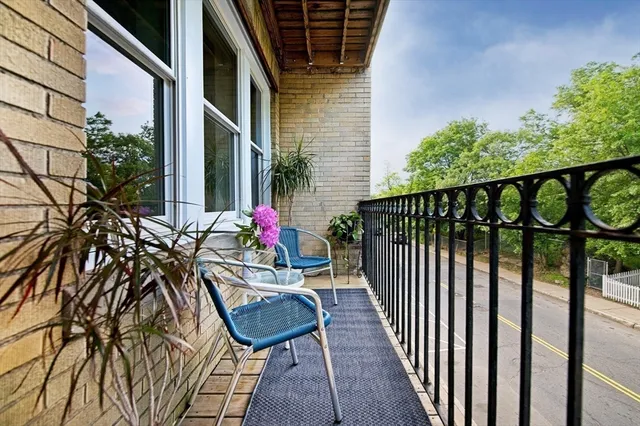 a view of balcony with wooden floor and bench