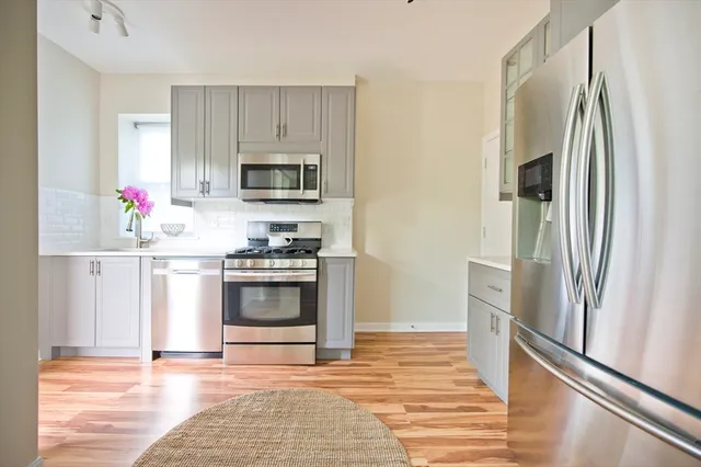 a kitchen with granite countertop a refrigerator and a stove
