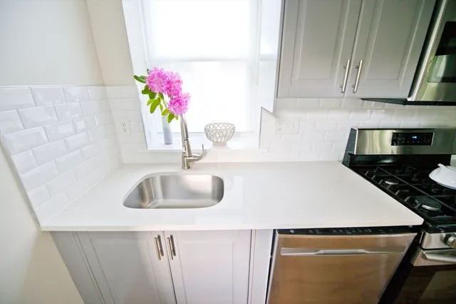 a kitchen with a sink and cabinets