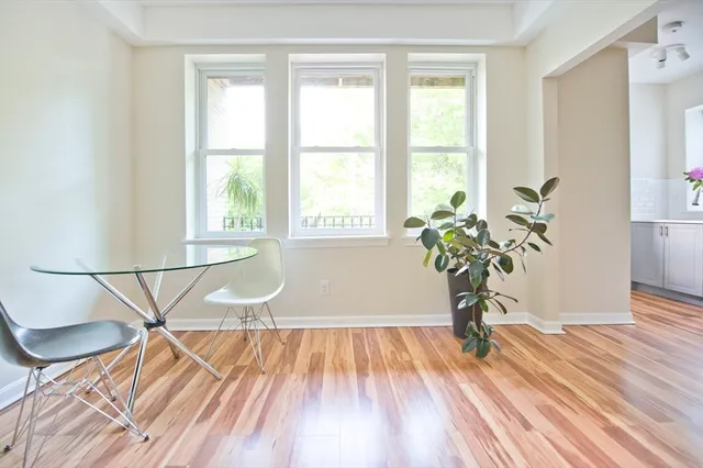 a view of a room with wooden floor and a window