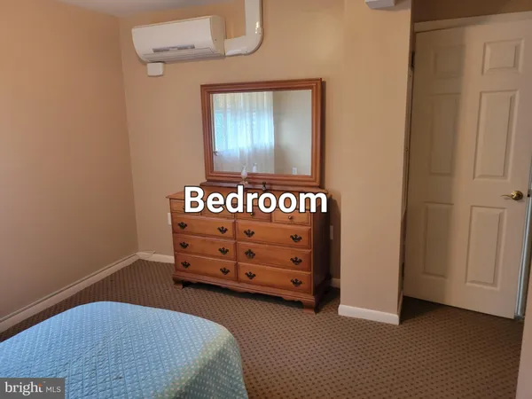 a view of a bedroom with closet and cabinet