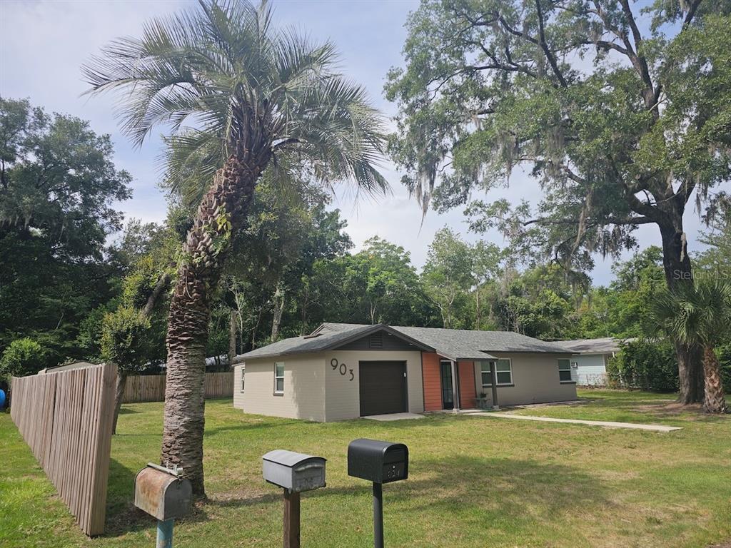 903 Northwest 33rd Avenue Gainesville, FL 32609 - Photo 2 of 23 a white house that has a tree in it
