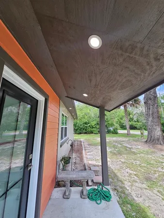 a view of a porch with furniture and front door