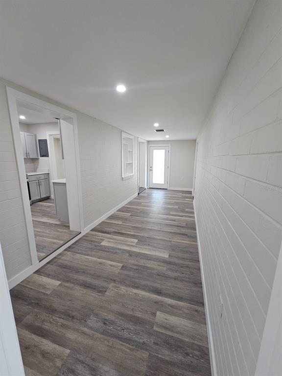 903 Northwest 33rd Avenue Gainesville, FL 32609 - Photo 5 of 23 a view of an empty room with wooden floor and a window