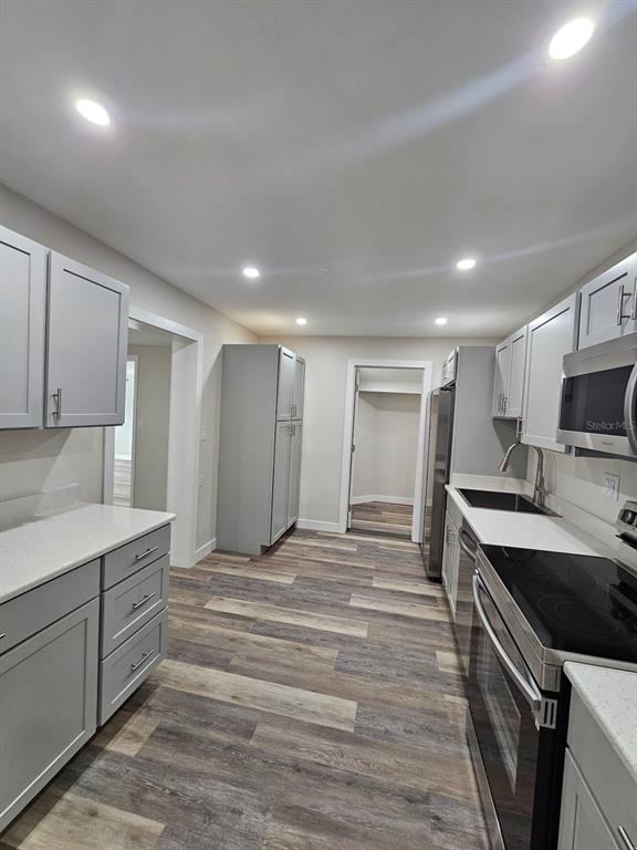 903 Northwest 33rd Avenue Gainesville, FL 32609 - Photo 7 of 23 a large kitchen with kitchen island a sink stainless steel appliances and cabinets