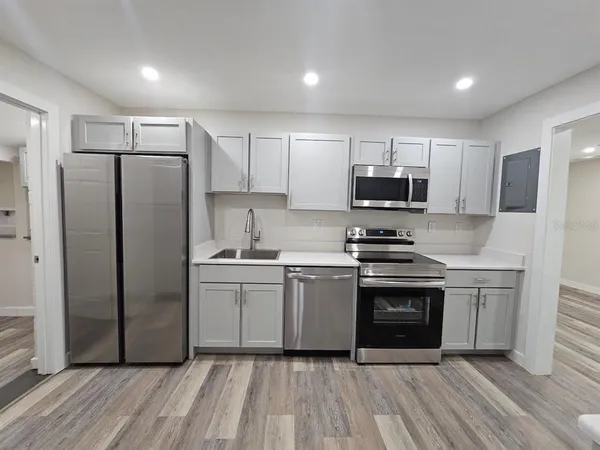 a kitchen with stainless steel appliances a refrigerator sink and stove