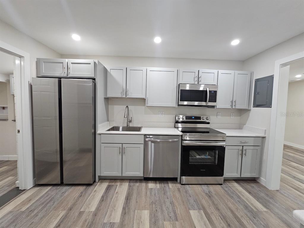 903 Northwest 33rd Avenue Gainesville, FL 32609 - Photo 8 of 23 a kitchen with stainless steel appliances a refrigerator sink and stove