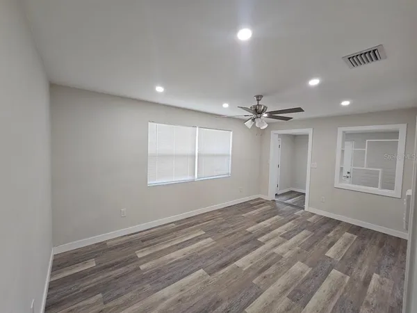 wooden floor in an empty room with a window