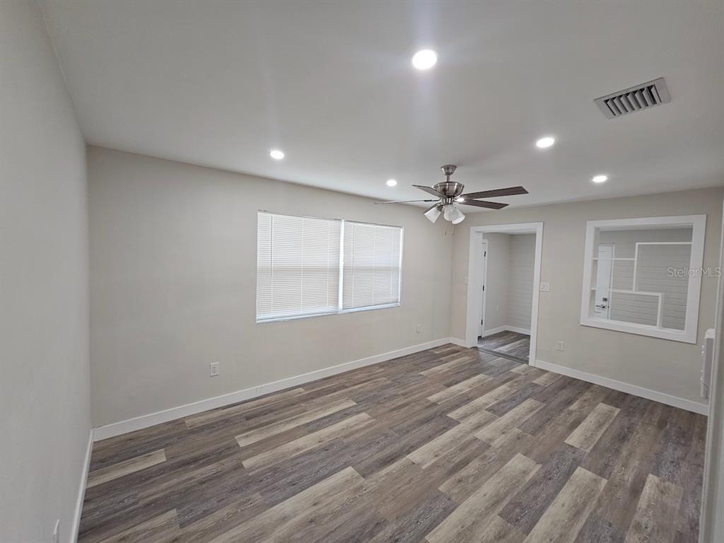 903 Northwest 33rd Avenue Gainesville, FL 32609 - Photo 9 of 23 wooden floor in an empty room with a window