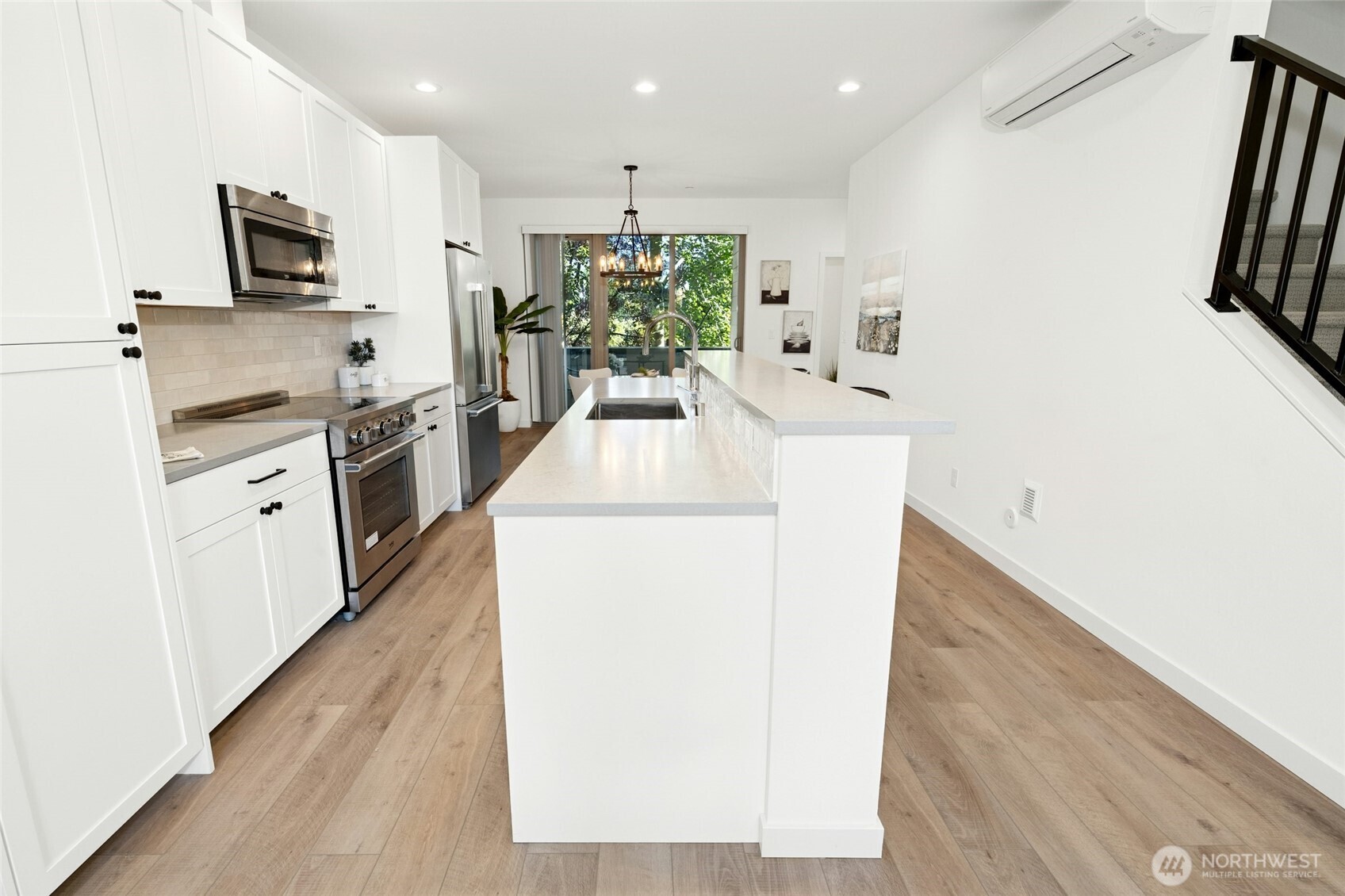 18512 Wallingford Avenue North Shoreline, WA 98133 - Photo 12 of 32 a kitchen with kitchen island a sink a stove a refrigerator and a microwave