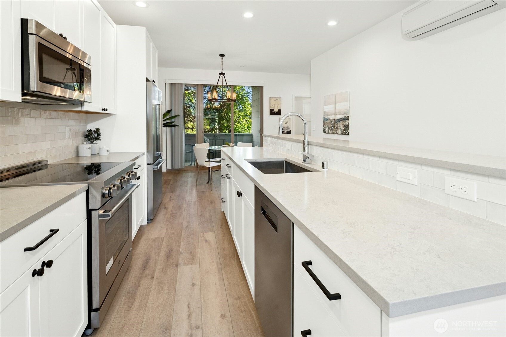 18512 Wallingford Avenue North Shoreline, WA 98133 - Photo 14 of 32 a kitchen with a sink a stove and cabinets