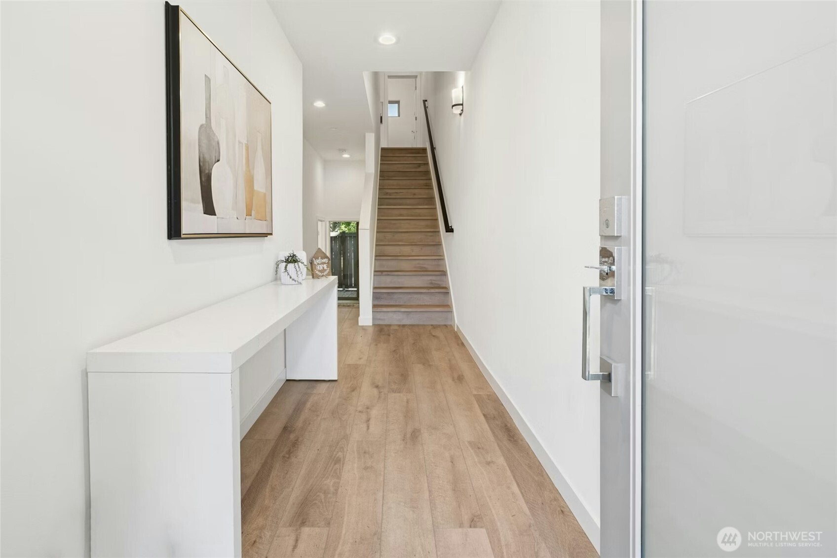 18512 Wallingford Avenue North Shoreline, WA 98133 - Photo 4 of 32 a view of a hallway with wooden floor and staircase