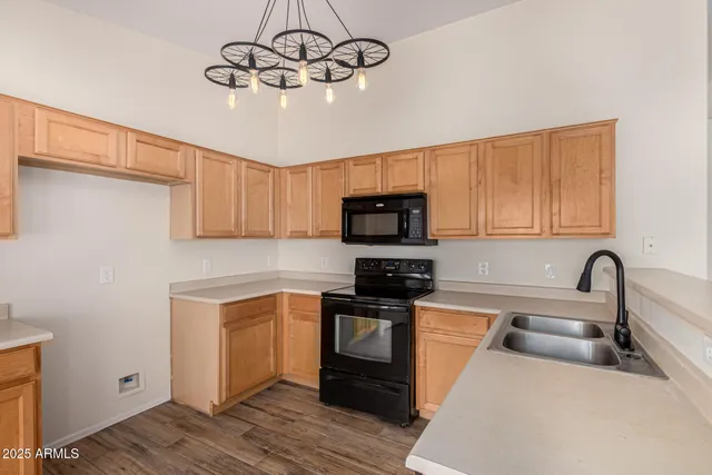a kitchen with stainless steel appliances sink a microwave and cabinets