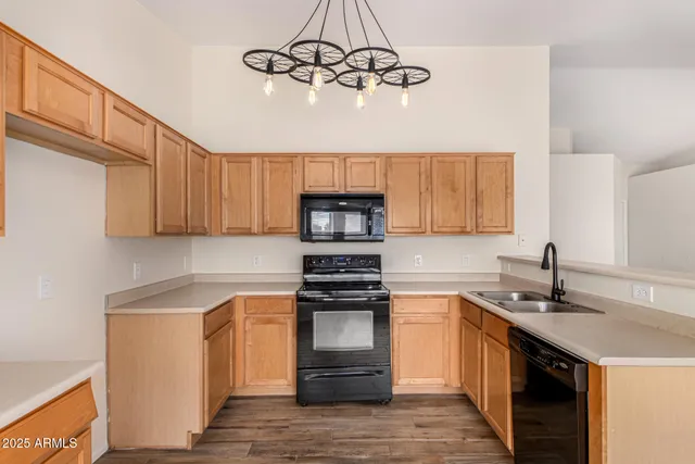 a kitchen with a sink cabinets stainless steel appliances and a window