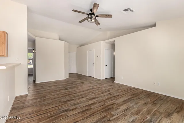 a view of empty room with wooden floor